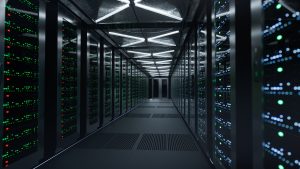 Data center aisle with racks of servers and blinking green/blue LEDs.